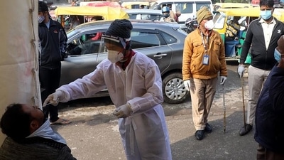 A healthcare worker collects a nasal swab sample of a man for the Covid-19 test amid a surge in Covid-19 and Omicron cases, in New Delhi. (AN) A healthcare worker collects a nasal swab sample of a man for the Covid-19 test amid a surge in Covid-19 and Omicron cases, in New Delhi. (AN)