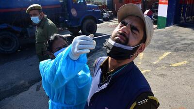A healthcare worker collects the nasal sample of a policeman for Covid testing in Jammu on Wednesday. (ANI Photo)