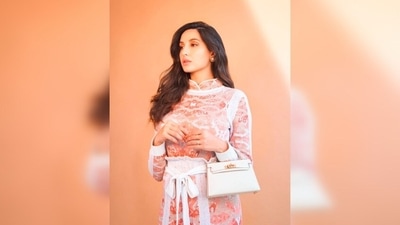 Nora Fatehi's outfit featured a jacquard knit top with qipao collar and a high-rise matching skirt. (Instagram/@manekaharisinghani) Nora Fatehi's outfit featured a jacquard knit top with qipao collar and a high-rise matching skirt. (Instagram/@manekaharisinghani)