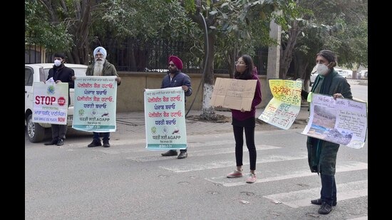 Members of Jalandhar-based NGO, Action Group Against Plastic Pollution. protesting outside MC’s Zone-D office in Sarabha Nagar, Ludhiana, on Wednesday. (Gurpreet Singh/HT)