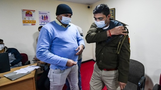 A Delhi police person after being administered a booster dose of COVID-19 vaccine at RML hospital in New Delhi.(PTI) A Delhi police person after being administered a booster dose of COVID-19 vaccine at RML hospital in New Delhi.(PTI)