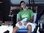 Serbian tennis player Novak Djokovic takes a break as he practices at Melbourne Park as questions remain over the legal battle regarding his visa to play in the Australian Open in Melbourne, Australia, January 13, 2022.