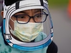 A student wears a mask and face shield while waiting for the first bell amid the Covid-19 pandemic at Washington Elementary School in Lynwood, Calif. (AP) A student wears a mask and face shield while waiting for the first bell amid the Covid-19 pandemic at Washington Elementary School in Lynwood, Calif. (AP)