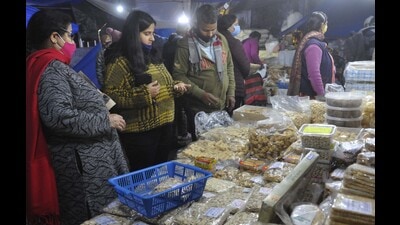 Residents purchasing Lohri fare at the Sector 20 market in Chandigarh. Dry fruit sellers in Sector 26 say their business has been badly hit this year. (Keshav SIngh/HT)