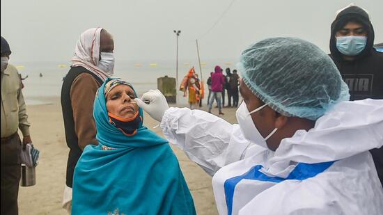 A health worker conducts Covid-19 testing as pilgrims arrive at Sagar Island in West Bengal on Wednesday. (PTI/File)