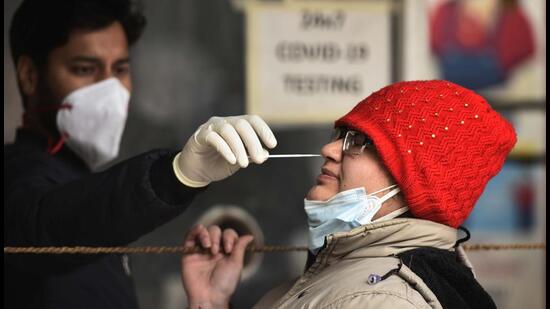 A health worker collects a swab sample for Covid-19 test, at Sector 31 UPHC in Gurugram on Wednesday. (Vipin Kumar /HT PHOTO)