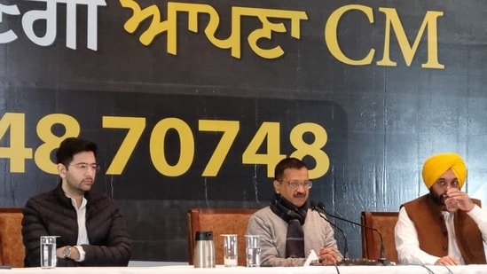 Delhi CM Arvind Kejriwal with Raghav Chadha (left) and Bhagwant Mann (right)