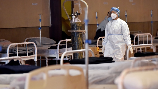 &nbsp;A healthcare worker wearing a PPE Kit walks inside a temporarily converted isolation ward for Covid-19 patients(ANI)