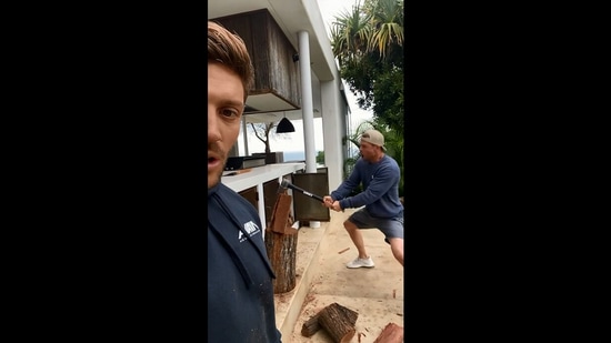 The image, taken from the video shared on Instagram, shows Chris Hemsworth trying to chop a piece of wood log.(Instagram/@chrishemsworth)