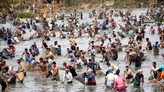 Villagers take part in a community fishing event during Bhogali Bihu celebrations at Goroimari Lake in Panbari, which is located around 50 kms from Guwahati.(PTI)