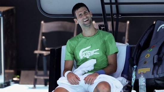 Serbian tennis player Novak Djokovic takes a break as he practices at Melbourne Park as questions remain over the legal battle regarding his visa to play in the Australian Open in Melbourne, Australia, January 13, 2022.(REUTERS)