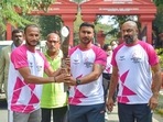 Hockey players V Raghunath (C) and Sunil Kumar (L) take part in a relay of the Queen's Baton for the Birmingham Commonwealth Games at Vidhanasoudha in Bengaluru, Friday, Jan. 14, 2022. Hockey players V Raghunath (C) and Sunil Kumar (L) take part in a relay of the Queen's Baton for the Birmingham Commonwealth Games at Vidhanasoudha in Bengaluru, Friday, Jan. 14, 2022.
