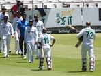 The Indian team marches out to congratulate Temba Bavuma and Rassie van Der Dussen after South Africa beat India 2-1 in a test series in Cape Town(AP)