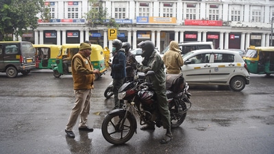 Delhi Police personnel checking vehicles during the weekend curfew to curb the spread of Covid-19 cases, at Connaught Place, in New Delhi. (Shrikant Singh) Delhi Police personnel checking vehicles during the weekend curfew to curb the spread of Covid-19 cases, at Connaught Place, in New Delhi. (Shrikant Singh)