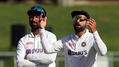 India's Virat Kohli and Cheteshwar Pujara react&nbsp; (REUTERS)