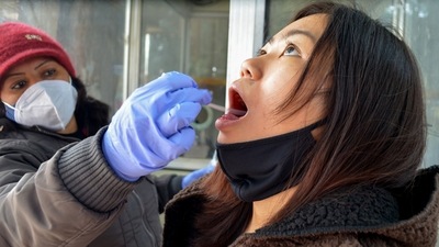 A health worker collects swab sample of a woman for the Covid-19 test, amid concerns over rising Omicron cases. (PTI) A health worker collects swab sample of a woman for the Covid-19 test, amid concerns over rising Omicron cases. (PTI)
