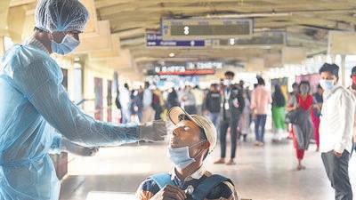 A healthcare worker collects swab samples for Covid-19 of passengers arriving on outstation trains, at Andheri station in Mumbai on Thursday. The EC last week had banned all election rallies in five poll-bound states. (HT photo) A healthcare worker collects swab samples for Covid-19 of passengers arriving on outstation trains, at Andheri station in Mumbai on Thursday. The EC last week had banned all election rallies in five poll-bound states. (HT photo)