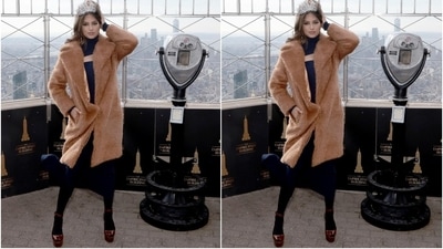 Harnaaz teamed the blue dress with black stockings, brown peep-toe high heels, statement rings, and silver drop earrings. She layered it with a faux fur beige overcoat to stay warm. In the end, the shimmering Miss Universe crown became the highlight of Harnaaz's look. (Instagram/@harnaazsandhu_03) Harnaaz teamed the blue dress with black stockings, brown peep-toe high heels, statement rings, and silver drop earrings. She layered it with a faux fur beige overcoat to stay warm. In the end, the shimmering Miss Universe crown became the highlight of Harnaaz's look. (Instagram/@harnaazsandhu_03)