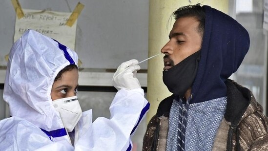 A health worker collecting swab samples for Covid tetsing at Urban Community Health Centre in Ludhiana. (HT Photo)