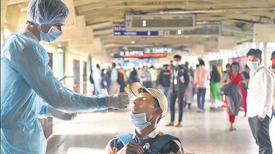 A healthcare worker collects swab samples for Covid-19 of passengers arriving on outstation trains, at Andheri station in Mumbai on Thursday. The EC last week had banned all election rallies in five poll-bound states. (HT photo) A healthcare worker collects swab samples for Covid-19 of passengers arriving on outstation trains, at Andheri station in Mumbai on Thursday. The EC last week had banned all election rallies in five poll-bound states. (HT photo)