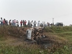 People take a look at the overturned car which was destroyed in violence during farmers' protest, at Tikonia area of Lakhimpur Kheri district, on October 4, 2021. (PTI) People take a look at the overturned car which was destroyed in violence during farmers' protest, at Tikonia area of Lakhimpur Kheri district, on October 4, 2021. (PTI)