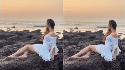 Mouni teamed the pristine white crop top with a matching skirt. The mini length bottoms also came adorned with intricate floral embroidery that gave an elegant touch to the Brahmastra actor's beach look. Additionally, it features cut-out lace on the hem, layered details and a ruched high-rise waistline. (Instagram/@imouniroy) Mouni teamed the pristine white crop top with a matching skirt. The mini length bottoms also came adorned with intricate floral embroidery that gave an elegant touch to the Brahmastra actor's beach look. Additionally, it features cut-out lace on the hem, layered details and a ruched high-rise waistline. (Instagram/@imouniroy)