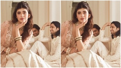 The midriff-baring gold moti studded blouse came with a flowy ivory white skirt with details in zari and mirrors. Sanjana paired it with a georgette dupatta embroidered in small mirrors. (Instagram/@sanjanasanghi96)