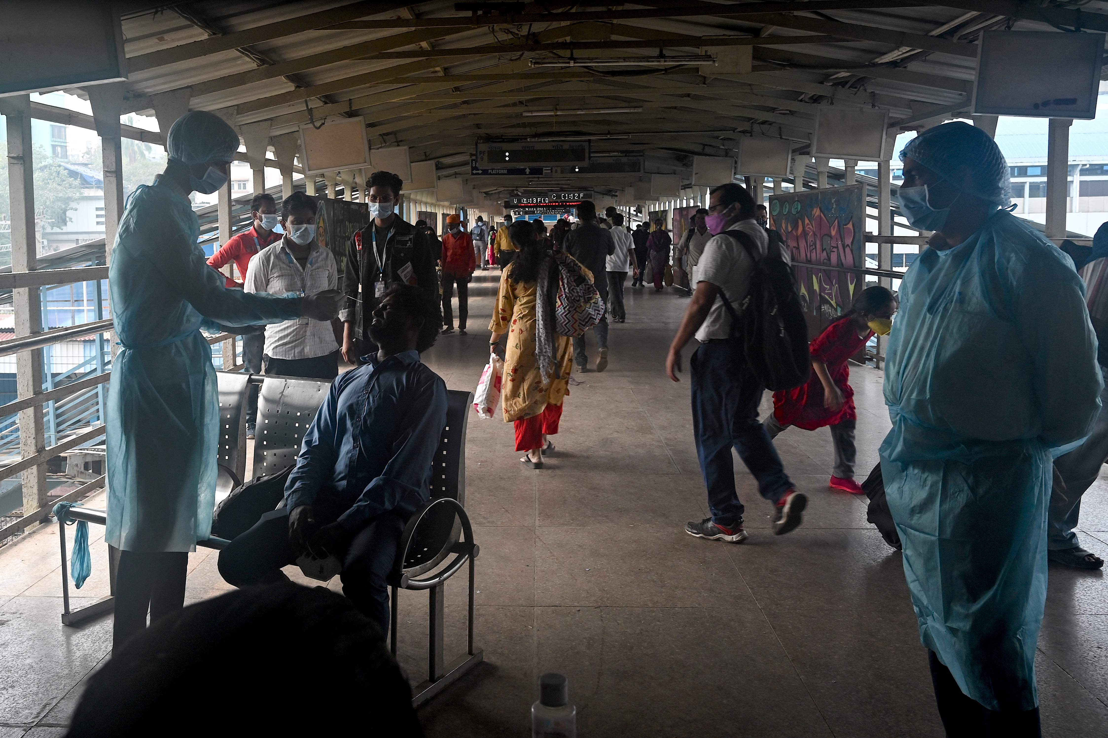A health worker collects a swab sample for RAT (Rapid Antigen Test) of an arriving passenger at a railway station in Mumbai. (AFP) A health worker collects a swab sample for RAT (Rapid Antigen Test) of an arriving passenger at a railway station in Mumbai. (AFP)