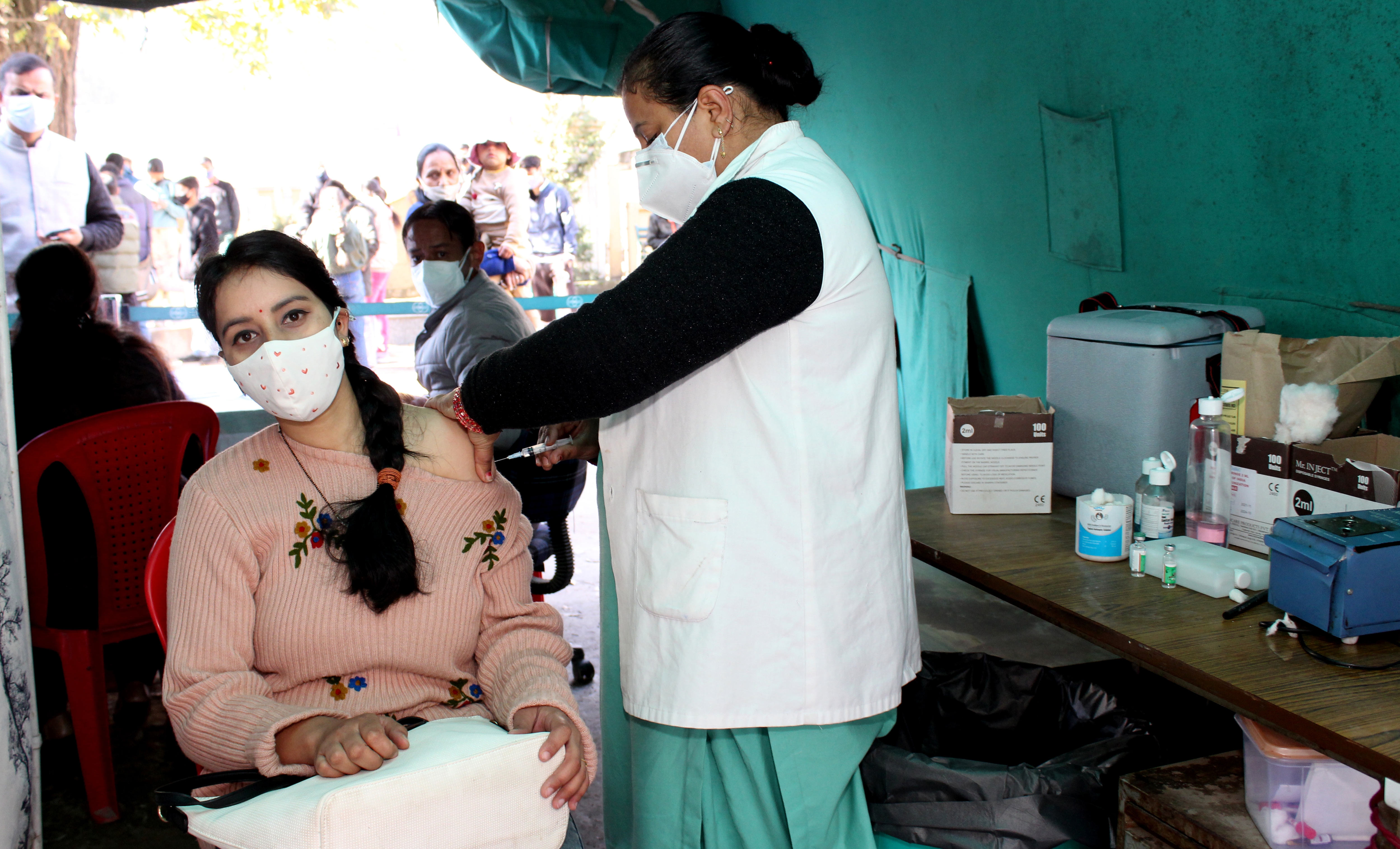 A health worker administers a dose of Covid-19 vaccine to a beneficiary.&nbsp; (Aqil Khan /HT Photo)