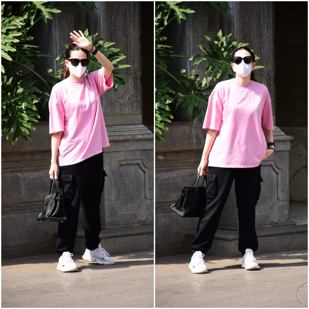 Karisma opted for a pink T-shirt, black pants and white sneakers.