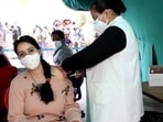 A health worker administers a dose of Covid-19 vaccine to a beneficiary. (Aqil Khan /HT Photo)