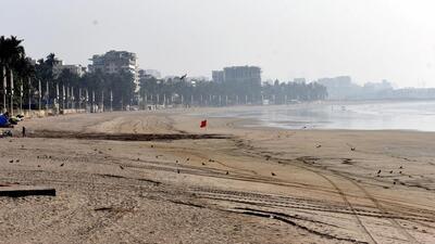 A deserted Juhu Chowpatty amid new restrictions imposed by the authorities due to Covid-19 pandemic in Mumbai on Sunday. Daily cases and the positivity rate declined on Sunday. (PTI) A deserted Juhu Chowpatty amid new restrictions imposed by the authorities due to Covid-19 pandemic in Mumbai on Sunday. Daily cases and the positivity rate declined on Sunday. (PTI)