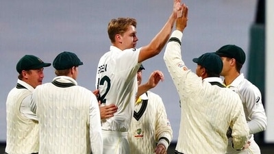 Australia's Cameron Green, center, celebrates with teammates taking the wicket of England's Zak Crawley during their Ashes Test at Hobart. (AP)