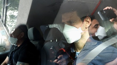 Serbian tennis player Novak Djokovic departs the Park Hotel while under immigration detention, to convene with his legal team after his visa to play in the Australian Open was cancelled a second time, in Melbourne, Australia, January 16, 2022. (REUTERS)