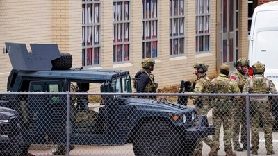 Law enforcement teams stage near Congregation Beth Israel while conducting SWAT operations in the 6100 block of Pleasant Run Road in Colleyville, Texas. (AP) Law enforcement teams stage near Congregation Beth Israel while conducting SWAT operations in the 6100 block of Pleasant Run Road in Colleyville, Texas. (AP)