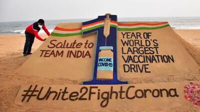 Sand artist Sudarsan Pattnaik creates a sand sculpture celebrating 1 year of India's Covid-19 vaccination drive, at Puri beach, on Sunday. (PTI) Sand artist Sudarsan Pattnaik creates a sand sculpture celebrating 1 year of India's Covid-19 vaccination drive, at Puri beach, on Sunday. (PTI)