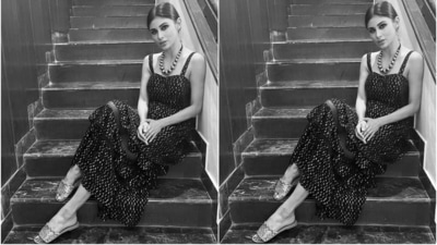 Mouni slipped into a sleeveless black embellished dress for the pictures. It features gold beaded embellishments all over the dress and broad straps. (Instagram/@imouniroy) Mouni slipped into a sleeveless black embellished dress for the pictures. It features gold beaded embellishments all over the dress and broad straps. (Instagram/@imouniroy)