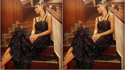 The ensemble comes with a sweetheart neckline, fitted bodice, flared skirt with layers and sheer panels, midi length and a feminine silhouette. (Instagram/@imouniroy) The ensemble comes with a sweetheart neckline, fitted bodice, flared skirt with layers and sheer panels, midi length and a feminine silhouette. (Instagram/@imouniroy)