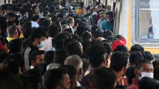 People crowd up at Dadar station flouting social distancing norms as they wait to board a local train as Central Railways operate Mega Block on its suburban sections for carrying out maintenance work, in Mumbai on Sunday. People crowd up at Dadar station flouting social distancing norms as they wait to board a local train as Central Railways operate Mega Block on its suburban sections for carrying out maintenance work, in Mumbai on Sunday.