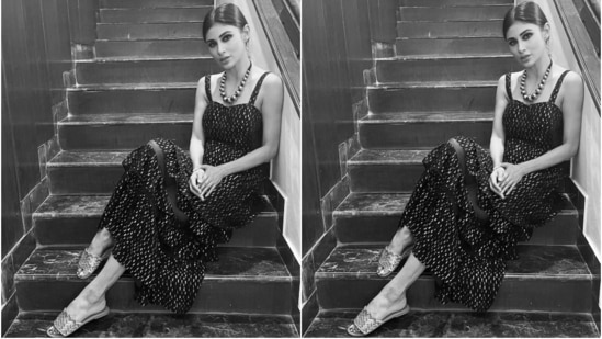 Mouni slipped into a sleeveless black embellished dress for the pictures. It features gold beaded embellishments all over the dress and broad straps.(Instagram/@imouniroy)