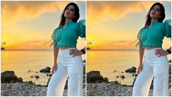 Sunny teamed a soft blue cropped top with a pair of white trousers with wide legs.(Instagram/@sunnyleone)