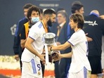 Karim Benzema and Luka Modric celebrate with the trophy after winning the Spanish Super Cup