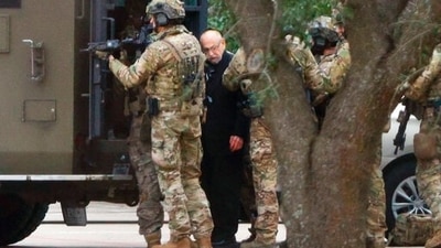 Authorities escort a hostage out of the Congregation Beth Israel synagogue in Colleyville, Texas. (AP) Authorities escort a hostage out of the Congregation Beth Israel synagogue in Colleyville, Texas. (AP)