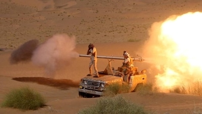 Yemeni government army soldiers fire a cannon mounted on a vehicle at the frontline of fighting against Houthis in Marib, Yemen in this undated photo provided by Yemen's Armed Forces on January 14, 2022.&nbsp; (via REUTERS)