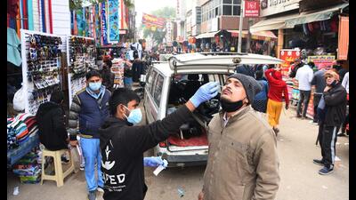 A health worker collects a swab sample for Covid-19 test at Sadar Bazar in Gurugram on Monday. (Vipin Kumar/HT)