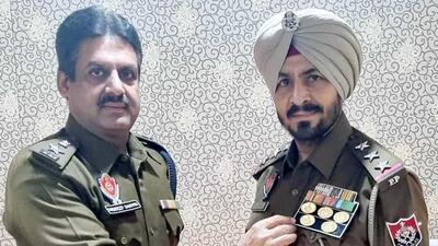 AIG Snehdeep Sharma awarded DGP commendation disc to Special Task Force in-charge Inspector Harbans Singh in Ludhiana. (HT File)