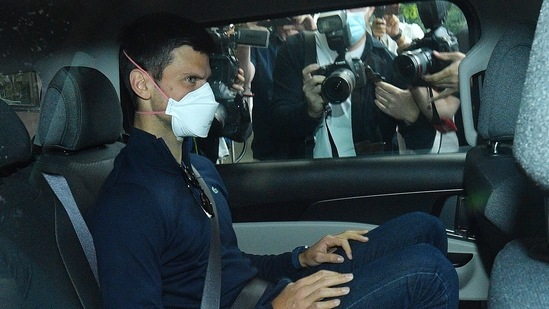 Serbian tennis player Novak Djokovic rides in car as he leaves a government detention facility before attending a court hearing at his lawyers office in Melbourne, Australia, Sunday, Jan. 16, 2022.(AP) Serbian tennis player Novak Djokovic rides in car as he leaves a government detention facility before attending a court hearing at his lawyers office in Melbourne, Australia, Sunday, Jan. 16, 2022.(AP)