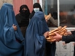 The United Nations has warned that half the country is threatened with food shortages. In picture - Women receive free bread distributed as part of the Save Afghans From Hunger campaign in front of a bakery in Kabul.(AFP) The United Nations has warned that half the country is threatened with food shortages. In picture - Women receive free bread distributed as part of the Save Afghans From Hunger campaign in front of a bakery in Kabul.(AFP)