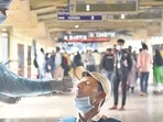 A healthcare worker collects swab samples for Covid-19 of passengers arriving on outstation trains, at Andheri station in Mumbai on Thursday. (HT photo) A healthcare worker collects swab samples for Covid-19 of passengers arriving on outstation trains, at Andheri station in Mumbai on Thursday. (HT photo)