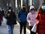 People wearing masks walk on a street during morning rush hour, as the Covid-19 pandemic continues in the country, in Beijing, China.(Reuters)